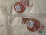 two cookies that are wrapped in plastic bags on a table