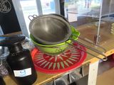 a colander with a strainer on top of it on a table