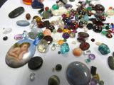 many different colored stones on a table with a picture of a baby