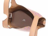 beige and pink handbag with floral design on strap and handle