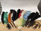 many different colored feathers in a box on a table