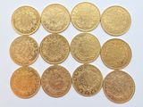 a close up of a bunch of gold coins on a white surface
