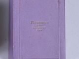 purple book with gold lettering on it sitting on a white surface