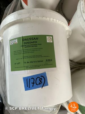 a bucket of white toilet paper sitting on top of a pile of toilet paper