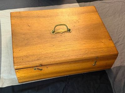 a wooden box that has a handle on it