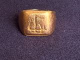 an image of a gold ring on a purple surface
