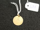 a close up of a gold coin on a string with a price tag