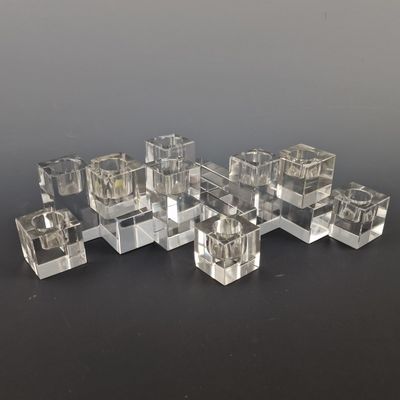 several clear cubes of glass sitting on top of a black surface