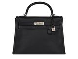 a black leather handbag on a white background