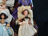 five dolls that are sitting next to each other on a black surface