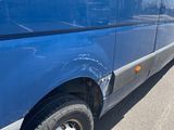 a blue van that is parked on the side of the road