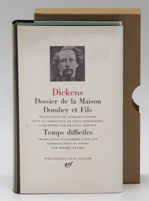 the book is open on a white surface with a picture of a man in a hat