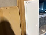 a refrigerator and a refrigerator freezer in a room