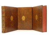 a brown book with a gold emblem on it