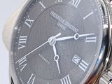 a close up of a watch with roman numerals on the face