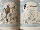 an open book with a picture of a man holding a sword