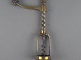 a close up of a bottle opener with a corkscrew on it