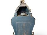 a small blue cabinet with a statue on top of it