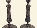 pair of antique brass candlesticks on a white background