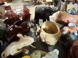 a table with a lot of pottery items on it