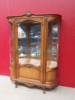 a wooden cabinet with a glass door on the side of it