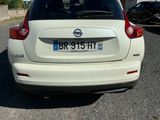 a white car that is parked in a parking lot