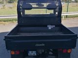 an image of a black utility truck parked in a parking lot