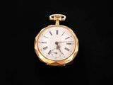 a gold pocket watch with roman numerals on it