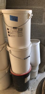 several buckets are stacked on top of each other in a room
