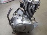 a motorcycle engine sitting on the floor in a room