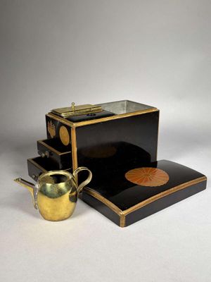 an image of a black and gold tea set with a cup and saucer