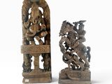 pair of carved wooden sculptures of a hindu god and a demon