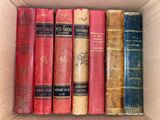 a box full of old books sitting on a table