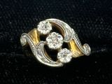 an image of a gold and diamond ring on a black cloth