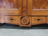 a wooden armoire with a star design on it