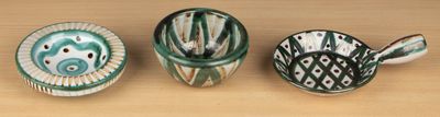 three vases sitting on a table next to each other