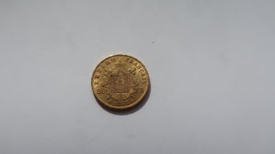 an old gold coin on a white surface