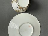 a cup and saucer on a table with a saucer