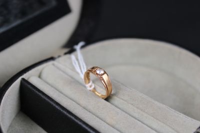 a wedding ring in a ring box on a table