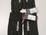 three pairs of black gloves with white logos on them