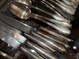 a lot of silver spoons and spoon spoons on the counter