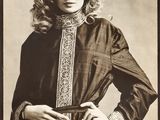 black and white photograph of a woman in a brown dress