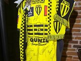 a mannequin wearing a yellow shirt with a scarf on it