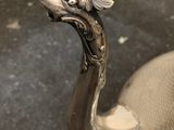 a statue of a dragon on a chair in a room