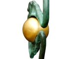 a statue of a bird with a golden egg on it ' s head