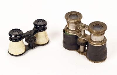 pair of antique binoculars on a white background with a white background