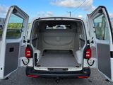 a white van with its doors open in a parking lot
