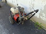 a small lawn mower parked on the side of the road