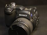 a sony camera sitting on a table with a black background