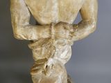 a statue of a man holding a baby in his lap